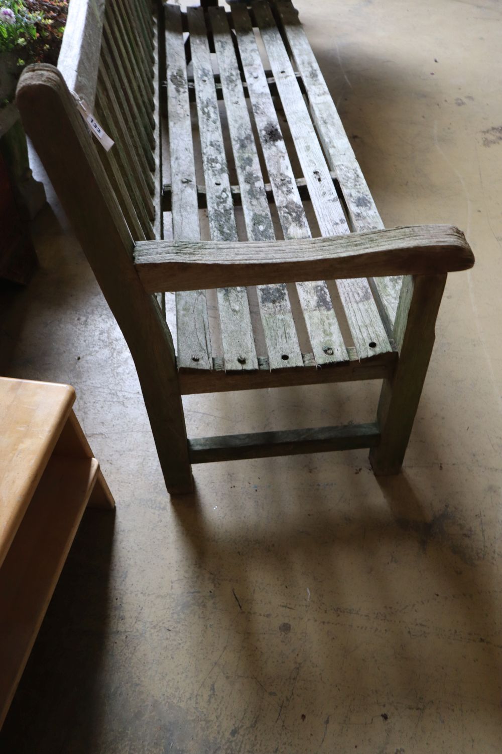 A weathered teak garden bench, length 79cm depth 60cm height 90cm